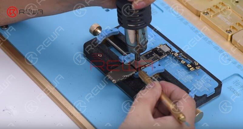 broken iphone revive - turn a nand flash chip into a usb flash drive Attach the logic board to the PCB Holder. Heat with the QUICK 858D helical wind hot air gun at 280℃, air flow 5 and remove black adhesive around the NAND first.