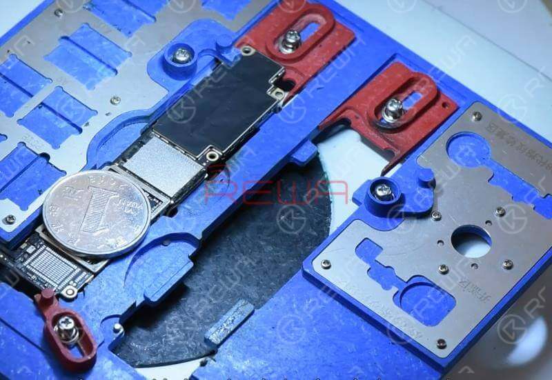 Heat with the QUICK 990AD Hot Air Gun to remove black adhesive around the NAND flash chip. Since there are multiple components around the NAND flash chip, to protect these components from high-temperature damage, we need to provide heat insulation by placing a coin.